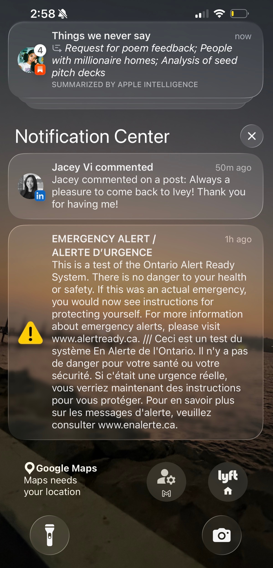 A phone lock screen stacked with notifications, including an emergency alert.